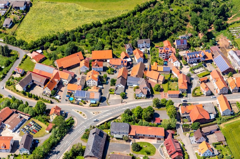 Giflitz from above - Agricultural land and field borders surround the settlement area of the village in Giflitz in the state Hesse, Germany