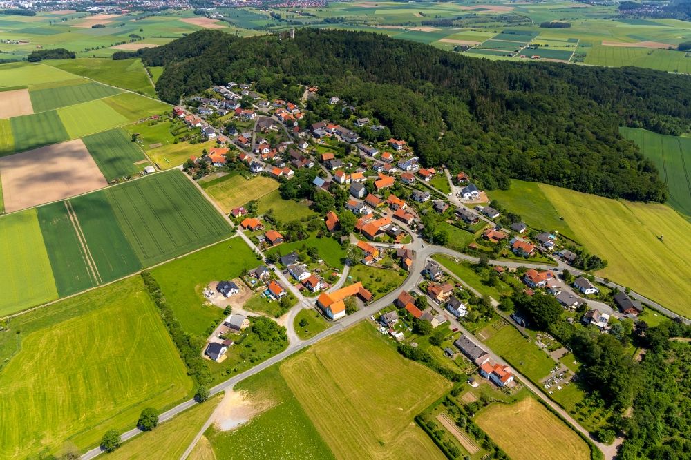 Goldhausen from the bird's eye view: Agricultural land and field borders surround the settlement area of the village in Goldhausen in the state Hesse, Germany
