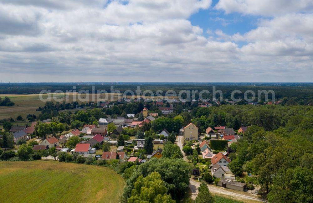Aerial image Grünefeld - Agricultural land and field borders surround the settlement area of the village in Gruenefeld in the state Brandenburg, Germany