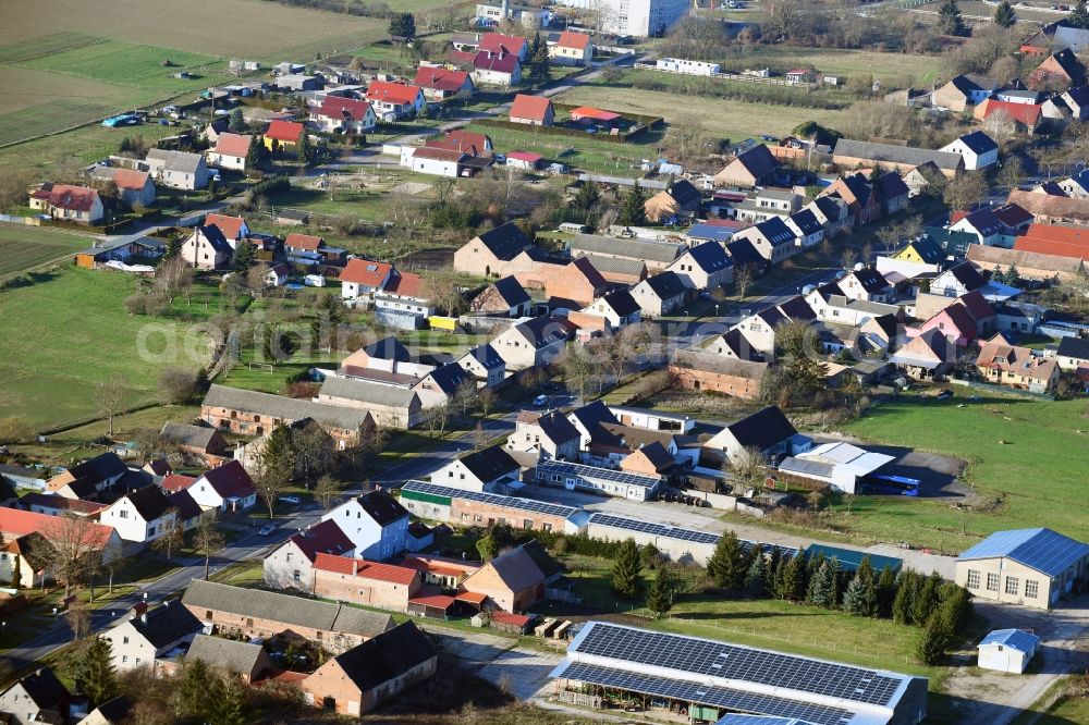 Großwoltersdorf from the bird's eye view: Agricultural land and field borders surround the settlement area of the village in Grosswoltersdorf in the state Brandenburg, Germany