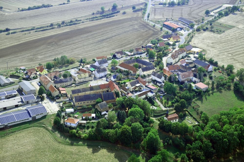 Größnitz from above - Agricultural land and field borders surround the settlement area of the village in Groessnitz in the state Saxony-Anhalt, Germany
