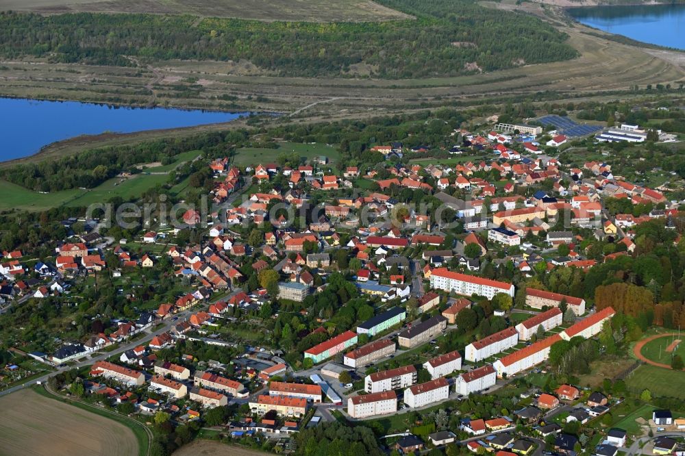 Harbke from above - Agricultural land and field borders surround the settlement area of the village in Harbke in the state Saxony-Anhalt, Germany