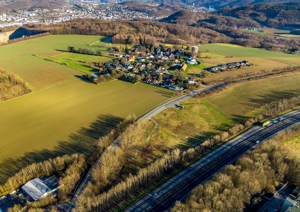 Haßley from above - Agricultural land and field borders surround the settlement area of the village in Hassley in the state North Rhine-Westphalia, Germany