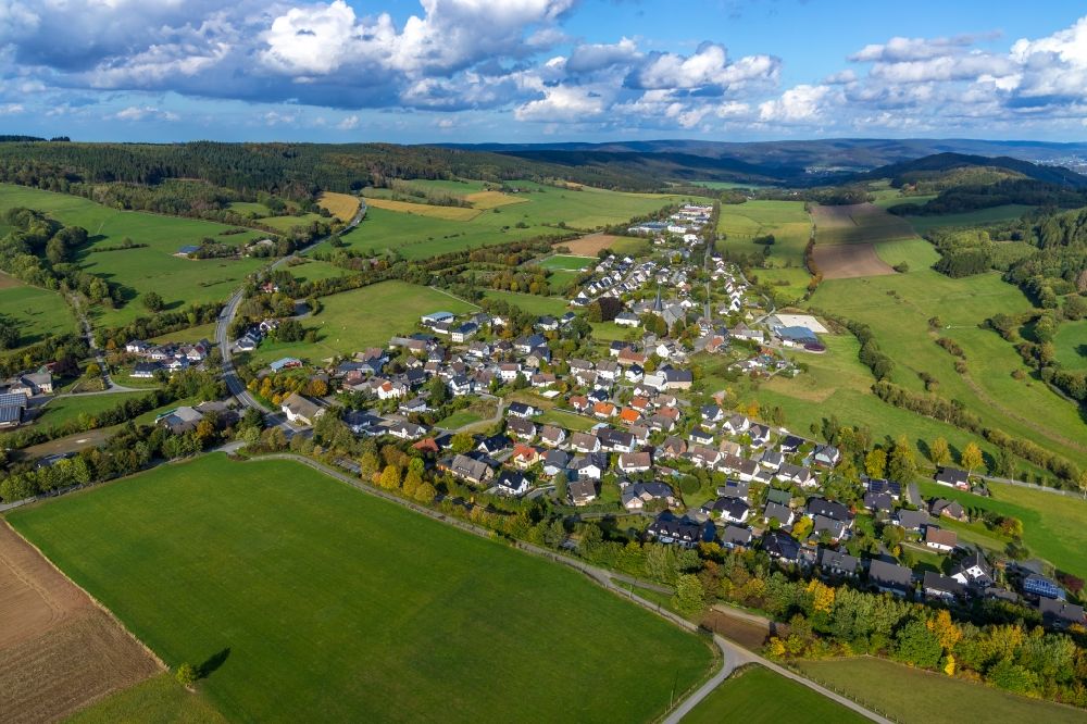 Aerial image Hellefeld - Agricultural land and field borders surround the settlement area of the village in Hellefeld in the state North Rhine-Westphalia, Germany