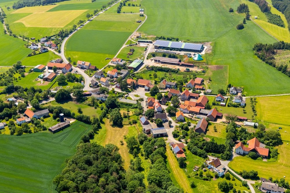 Helmscheid from the bird's eye view: Agricultural land and field borders surround the settlement area of the village in Helmscheid in the state Hesse, Germany