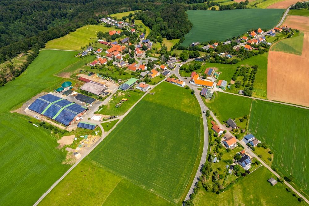 Aerial image Helmscheid - Agricultural land and field borders surround the settlement area of the village in Helmscheid in the state Hesse, Germany