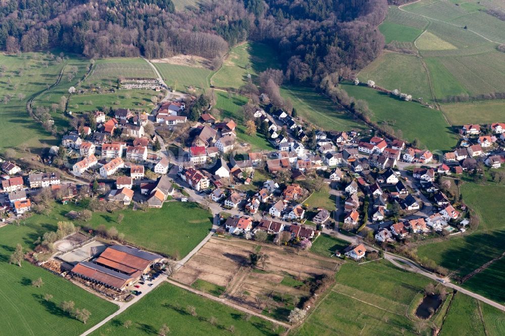 Heuweiler from above - Agricultural land and field borders surround the settlement area of the village in Heuweiler in the state Baden-Wurttemberg, Germany