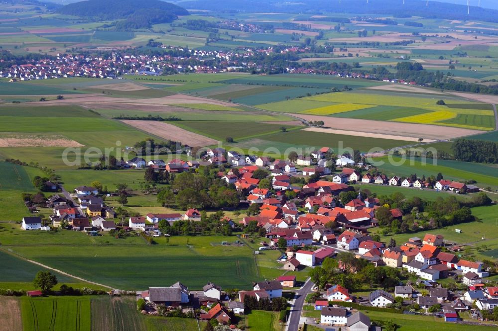 Aerial photograph Hilmes - Agricultural land and field borders surround the settlement area of the village in Hilmes in the state Hesse, Germany
