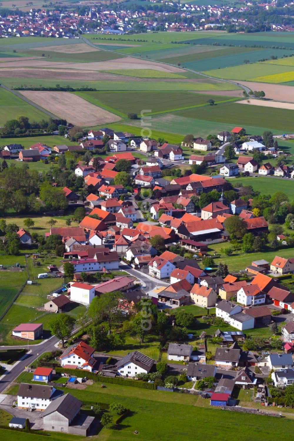 Aerial image Hilmes - Agricultural land and field borders surround the settlement area of the village in Hilmes in the state Hesse, Germany