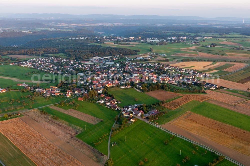 Aerial image Hochmössingen - Agricultural land and field borders surround the settlement area of the village in Hochmoessingen in the state Baden-Wurttemberg, Germany
