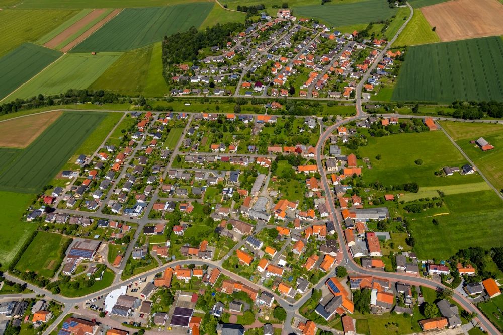 Aerial image Höringhausen - Agricultural land and field borders surround the settlement area of the village in Hoeringhausen in the state Hesse, Germany
