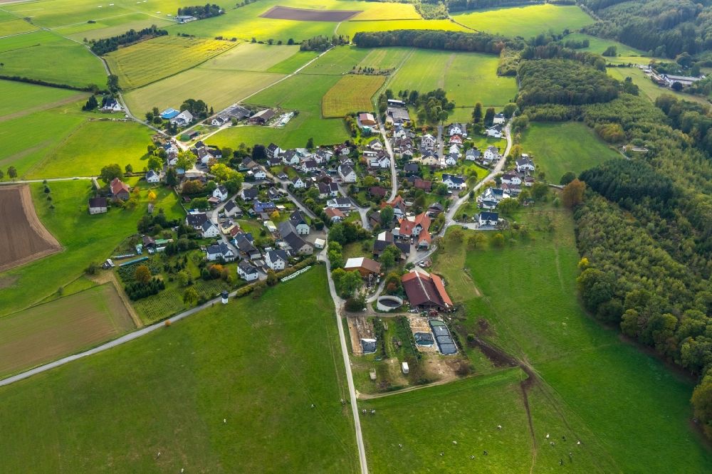 Aerial image Höveringhausen - Agricultural land and field borders surround the settlement area of the village in Hoeveringhausen in the state North Rhine-Westphalia, Germany