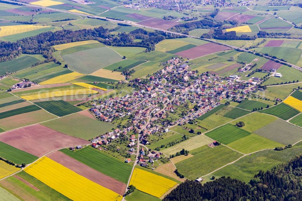 Irslingen from above - Agricultural land and field borders surround the settlement area of the village in Irslingen in the state Baden-Wurttemberg, Germany