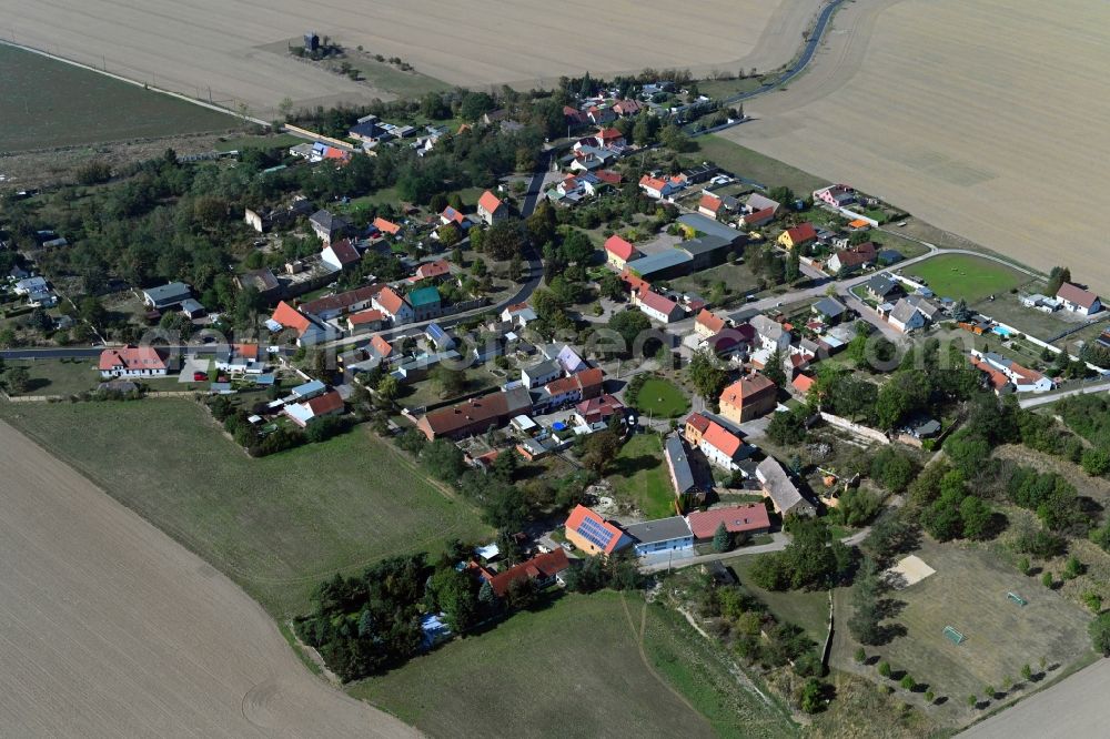 Köckern from above - Agricultural land and field borders surround the settlement area of the village in Koeckern in the state Saxony-Anhalt, Germany
