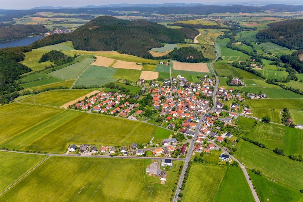 Aerial image Kleinern - Agricultural land and field borders surround the settlement area of the village in Kleinern in the state Hesse, Germany