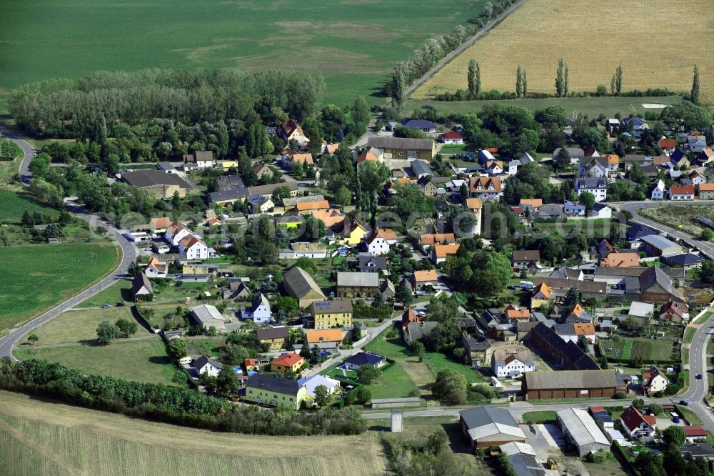 Aerial image Kölsa - Agricultural land and field borders surround the settlement area of the village in Koelsa in the state Saxony, Germany