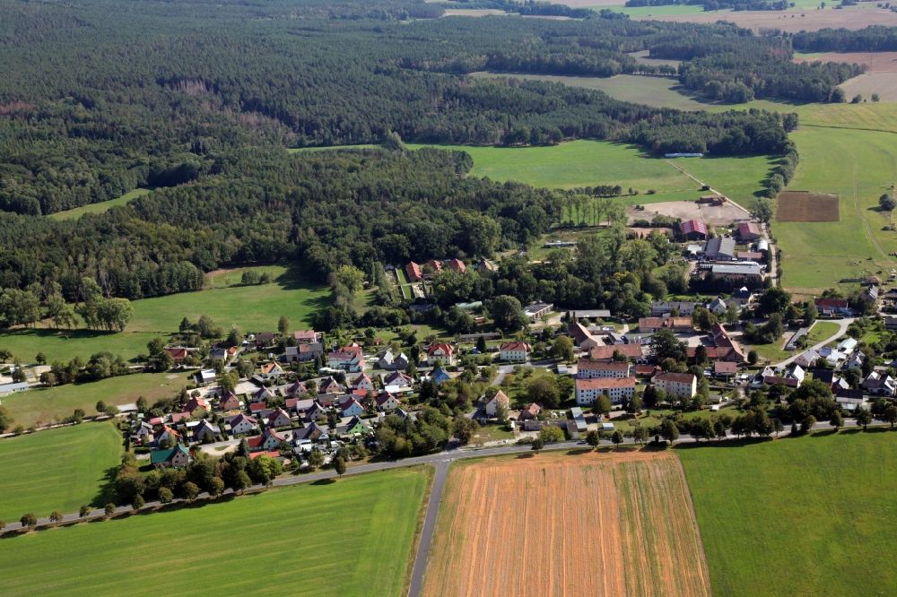 Koitzsch from above - Agricultural land and field borders surround the settlement area of the village in Koitzsch in the state Saxony, Germany