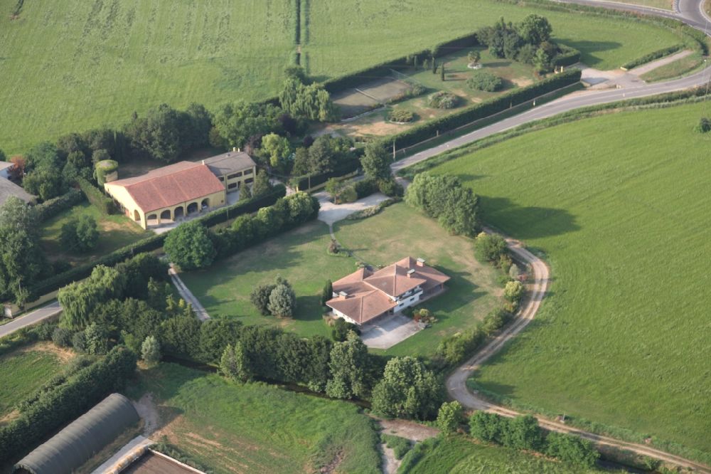 Marmirolo from above - Agricultural land and field borders surround the settlement area of the village in Marmirolo in the Lombardy, Italy