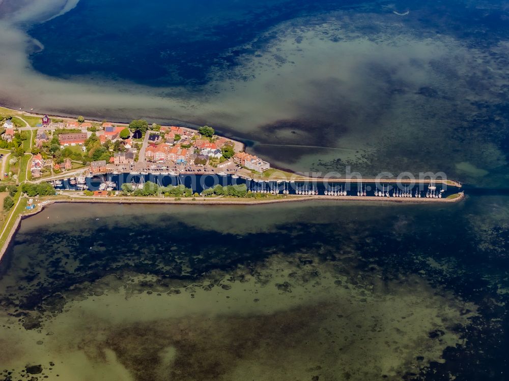 Fehmarn from the bird's eye view: Village center on the coastal area of the Baltic Sea in Orth auf Fehmarn in the state Schleswig-Holstein, Germany. The port and fishing village is located on the Orth Bay in the western part of the island of Fehmarn