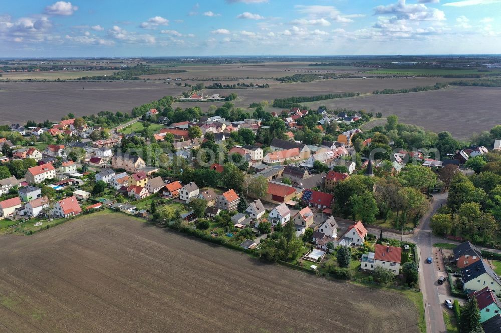 Mötzlich from above - Agricultural land and field borders surround the settlement area of the village in Moetzlich in the state Saxony-Anhalt, Germany