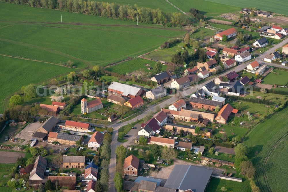Aerial image Mützlitz - Agricultural land and field borders surround the settlement area of the village in Muetzlitz in the state Brandenburg, Germany