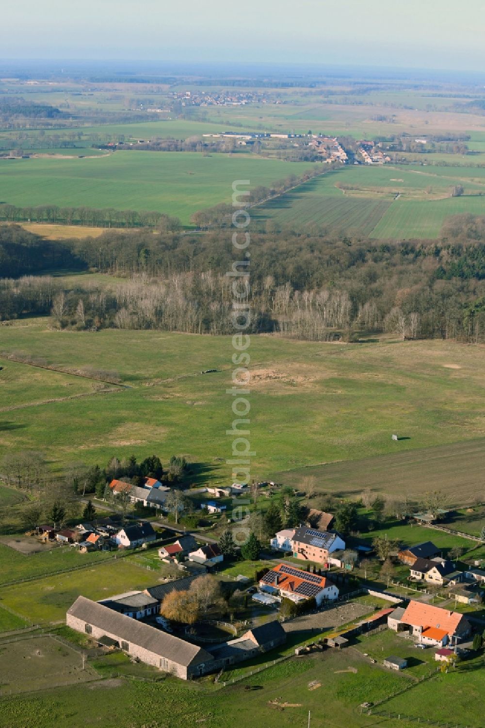 Neulüdersdorf from the bird's eye view: Agricultural land and field borders surround the settlement area of the village in Neuluedersdorf in the state Brandenburg, Germany