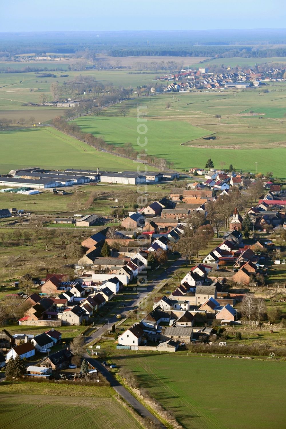 Aerial photograph Neulögow - Agricultural land and field borders surround the settlement area of the village in Neuloegow in the state Brandenburg, Germany