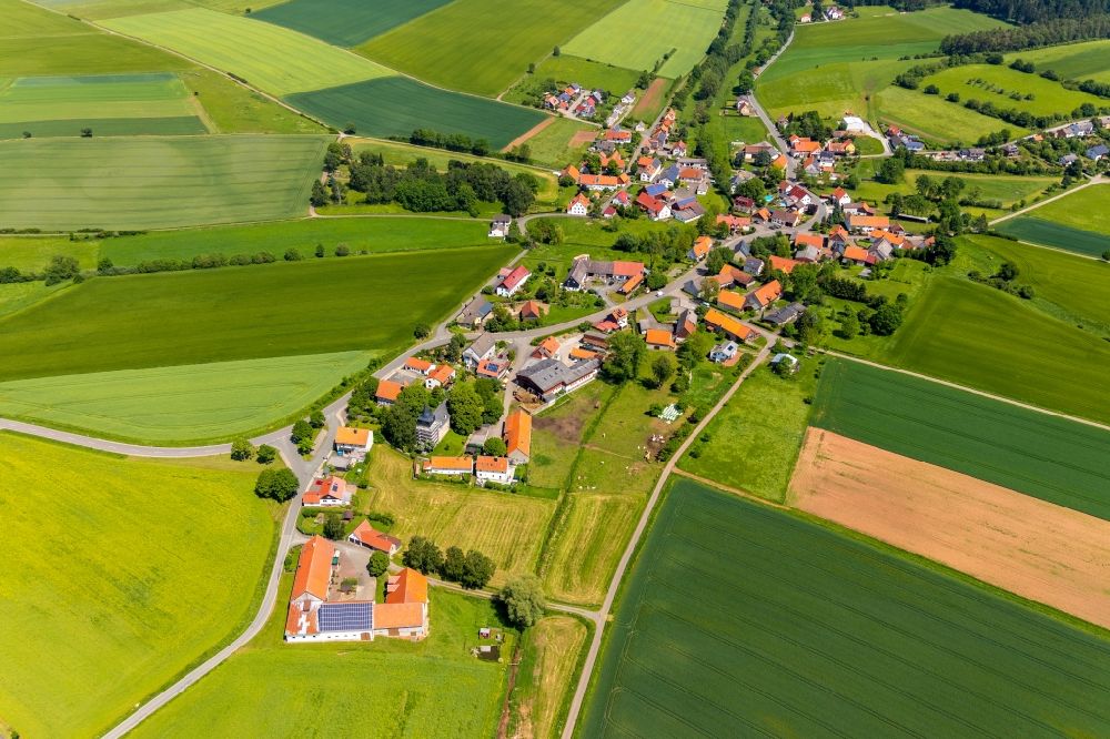 Aerial image Nieder-Ense - Agricultural land and field borders surround the settlement area of the village in Nieder-Ense in the state Hesse, Germany