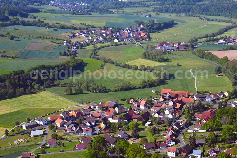 Aerial image Niederstoll - Agricultural land and field borders surround the settlement area of the village in Niederstoll in the state Hesse, Germany
