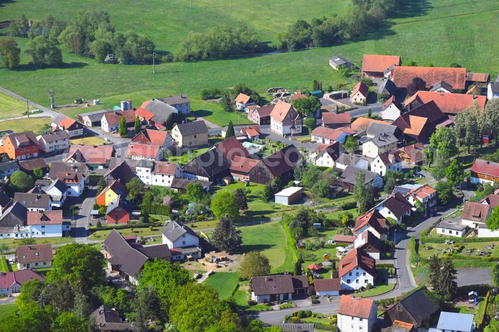 Aerial photograph Niederstoll - Agricultural land and field borders surround the settlement area of the village in Niederstoll in the state Hesse, Germany