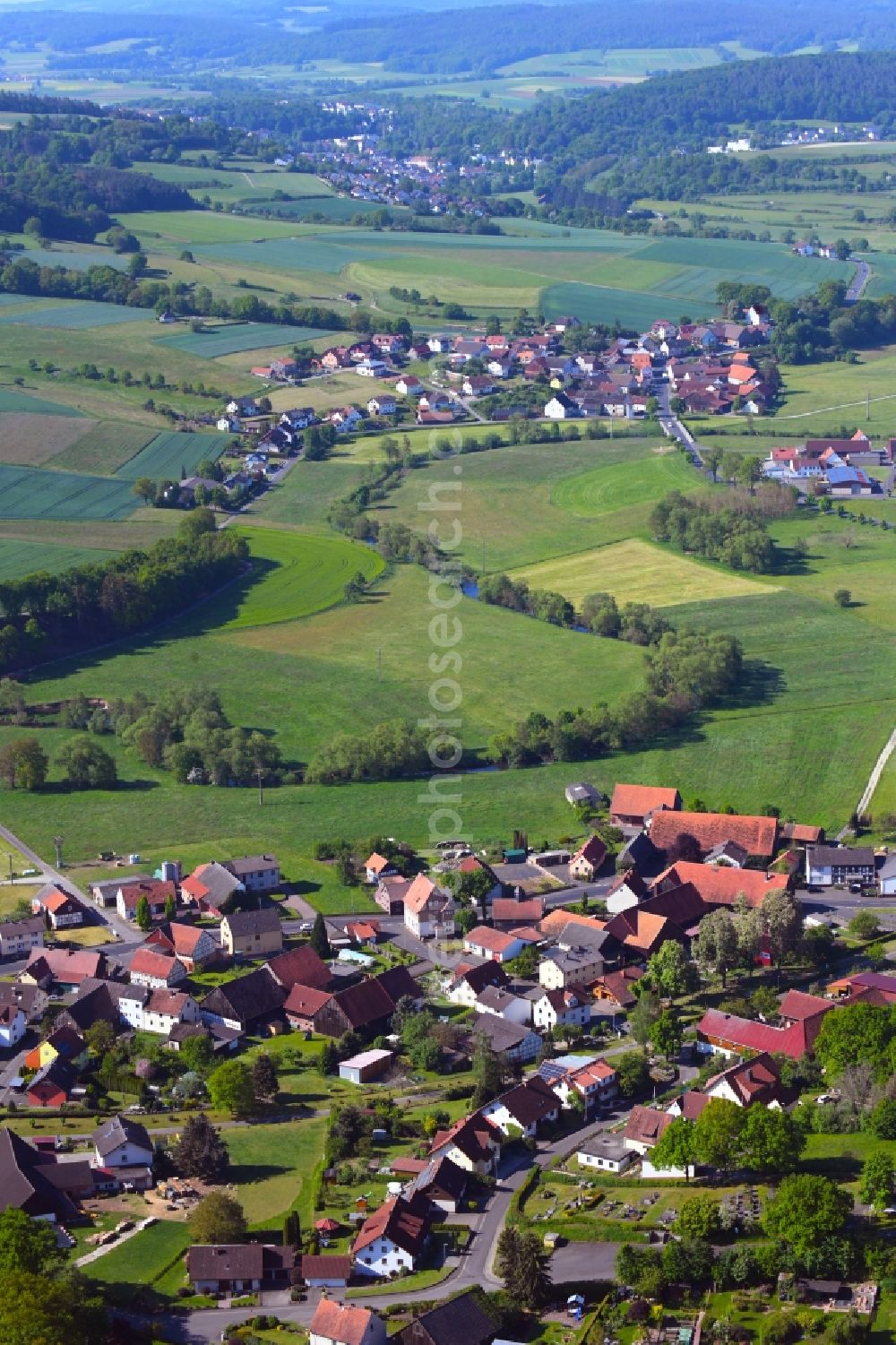 Niederstoll from above - Agricultural land and field borders surround the settlement area of the village in Niederstoll in the state Hesse, Germany