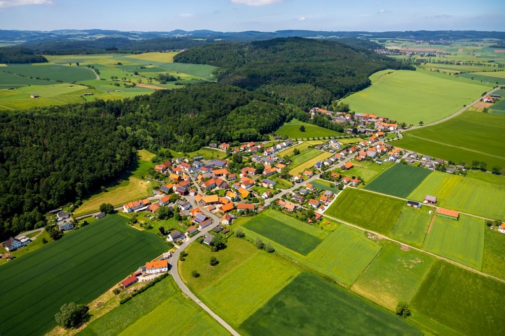Ober-Ense from above - Agricultural land and field borders surround the settlement area of the village in Ober-Ense in the state Hesse, Germany