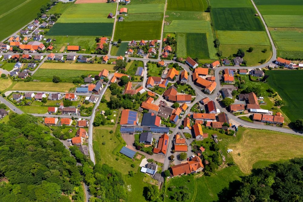 Ober-Ense from the bird's eye view: Agricultural land and field borders surround the settlement area of the village in Ober-Ense in the state Hesse, Germany