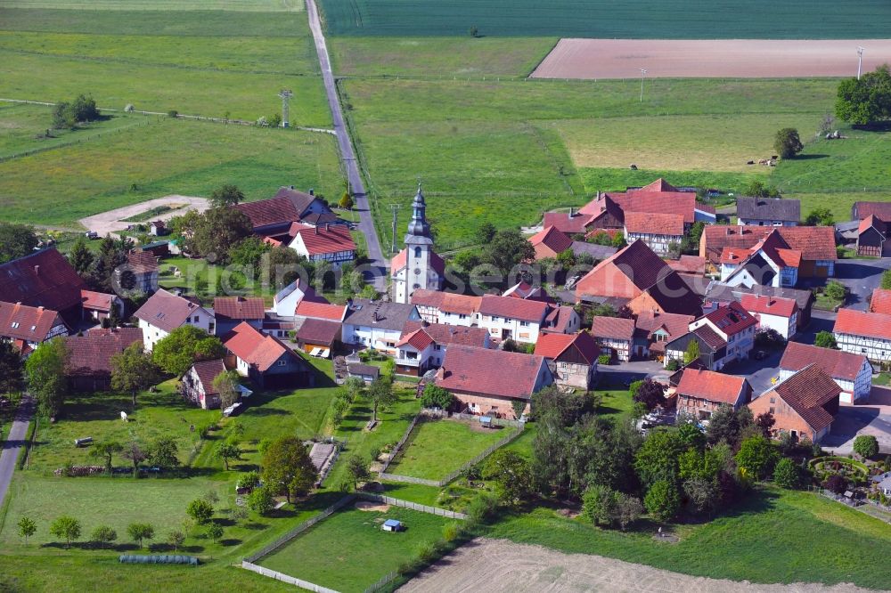 Aerial photograph Oberstoppel - Agricultural land and field borders surround the settlement area of the village in Oberstoppel in the state Hesse, Germany