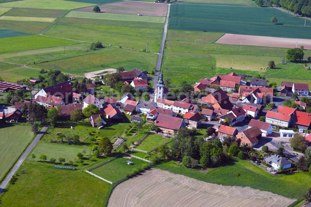 Oberstoppel from above - Agricultural land and field borders surround the settlement area of the village in Oberstoppel in the state Hesse, Germany