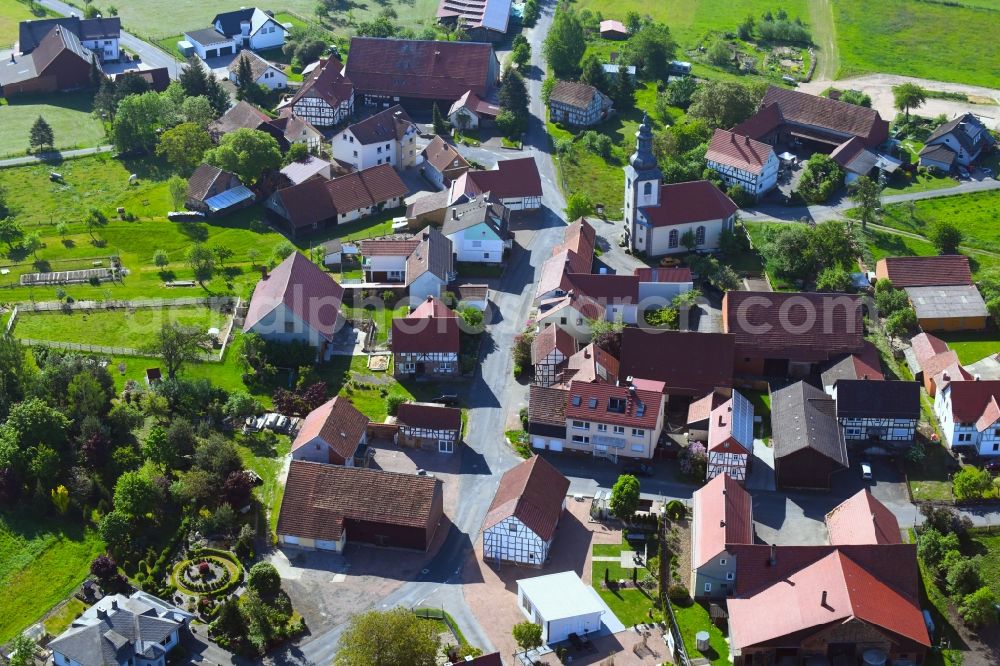 Aerial image Oberstoppel - Agricultural land and field borders surround the settlement area of the village in Oberstoppel in the state Hesse, Germany