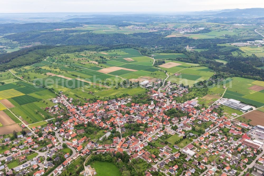 Ostdorf from above - Agricultural land and field borders surround the settlement area of the village in Ostdorf in the state Baden-Wurttemberg, Germany