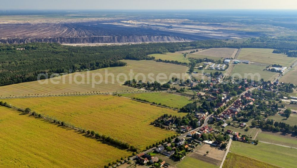 Aerial photograph Proschim - Agricultural land and field borders surround the settlement area of the village in Proschim in the state Brandenburg, Germany