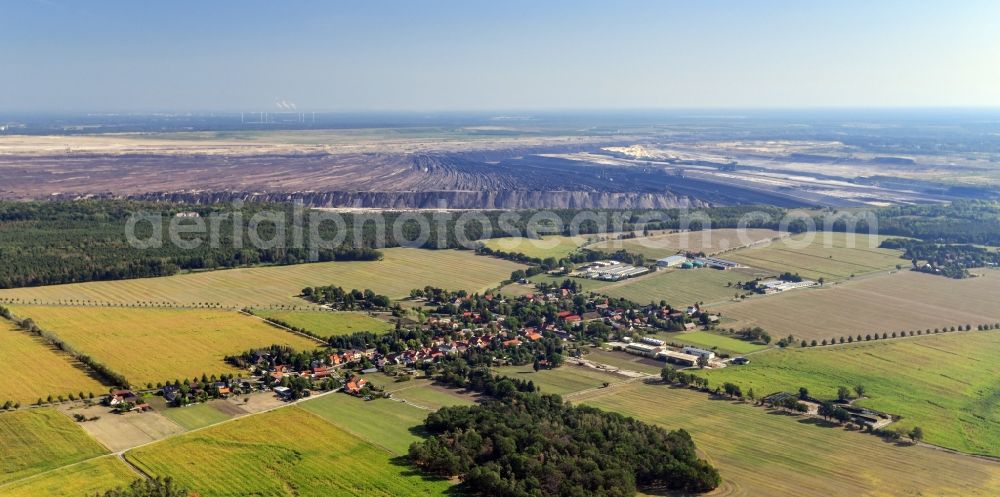 Aerial image Proschim - Agricultural land and field borders surround the settlement area of the village in Proschim in the state Brandenburg, Germany