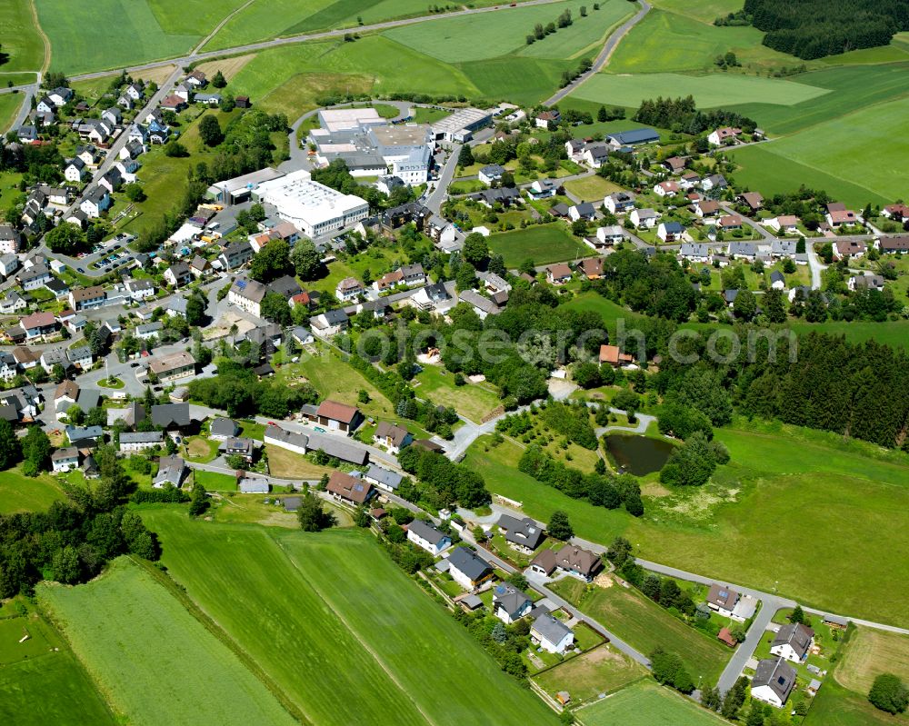 Marlesreuth from above - Agricultural land and field boundaries with the power plants surround the settlement area of the village in Marlesreuth in the state Bavaria, Germany