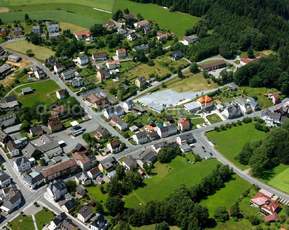 Oberhammer from the bird's eye view: Agricultural land and field boundaries with the power plants surround the settlement area of the village in Oberhammer in the state Bavaria, Germany