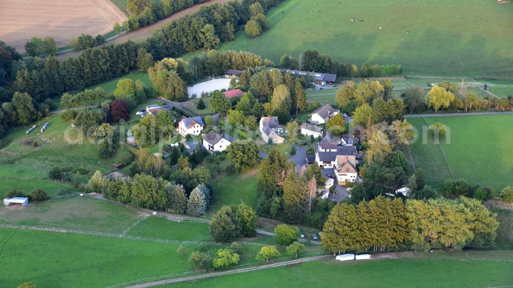 Schächer from the bird's eye view: Agricultural land and field borders surround the settlement area of the village in Schaecher in the state North Rhine-Westphalia, Germany