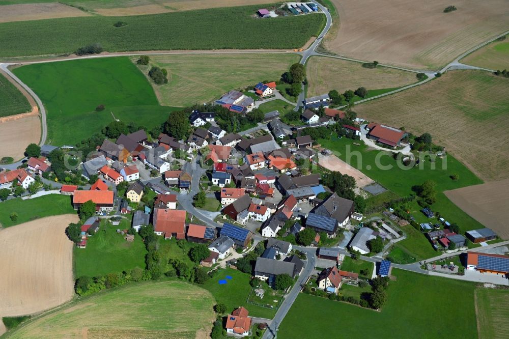 Seubersdorf from above - Agricultural land and field borders surround the settlement area of the village in Seubersdorf in the state Bavaria, Germany