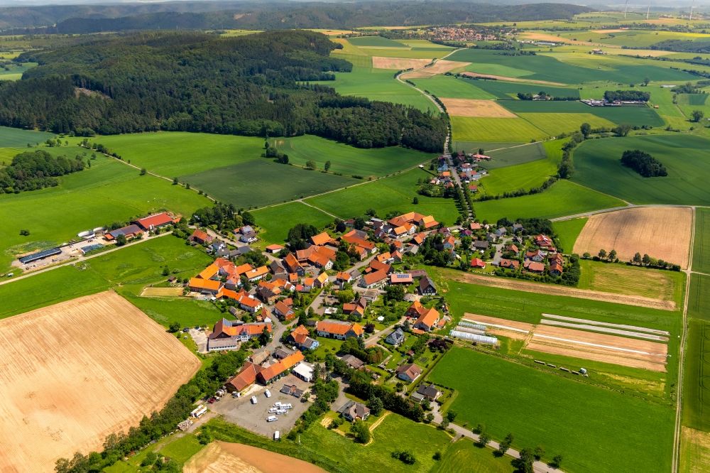 Strothe from above - Agricultural land and field borders surround the settlement area of the village in Strothe in the state Hesse, Germany