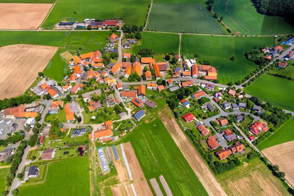 Aerial image Strothe - Agricultural land and field borders surround the settlement area of the village in Strothe in the state Hesse, Germany
