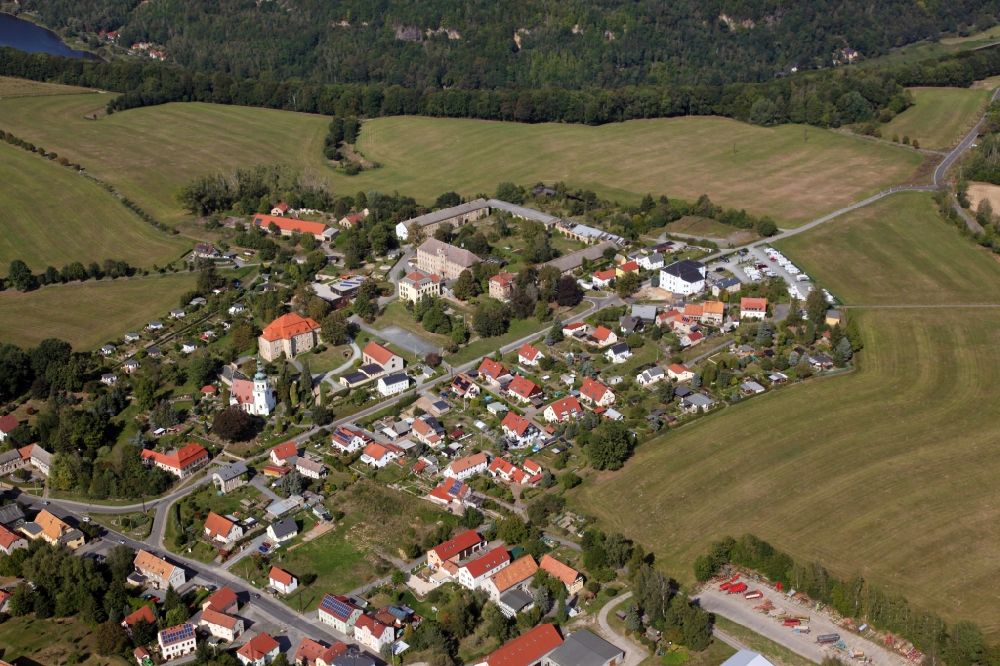 Aerial photograph Struppen - Agricultural land and field borders surround the settlement area of the village in Struppen in the state Saxony, Germany. Struppen Palace to the left of the center of the picture