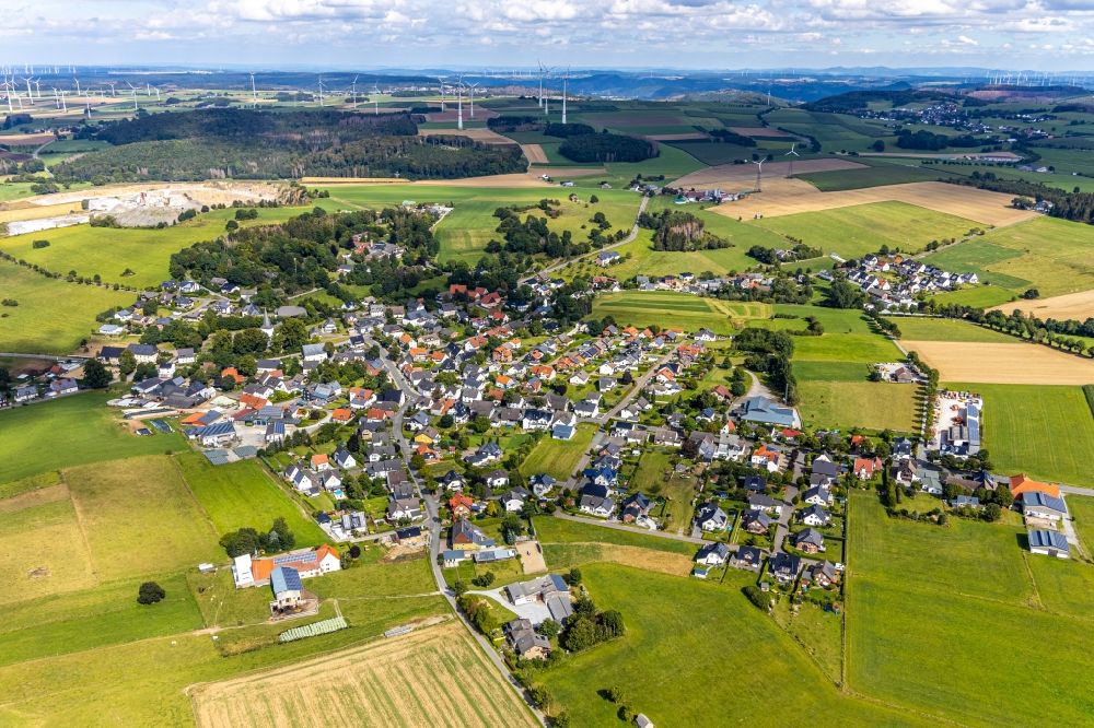 Thülen from the bird's eye view: Agricultural land and field borders surround the settlement area of the village in Thuelen in the state North Rhine-Westphalia, Germany