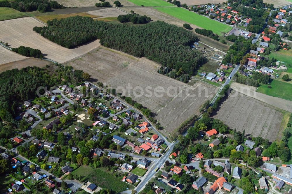 Aerial image Tramm - Agricultural land and field borders surround the settlement area of the village in Tramm in the state Lower Saxony, Germany