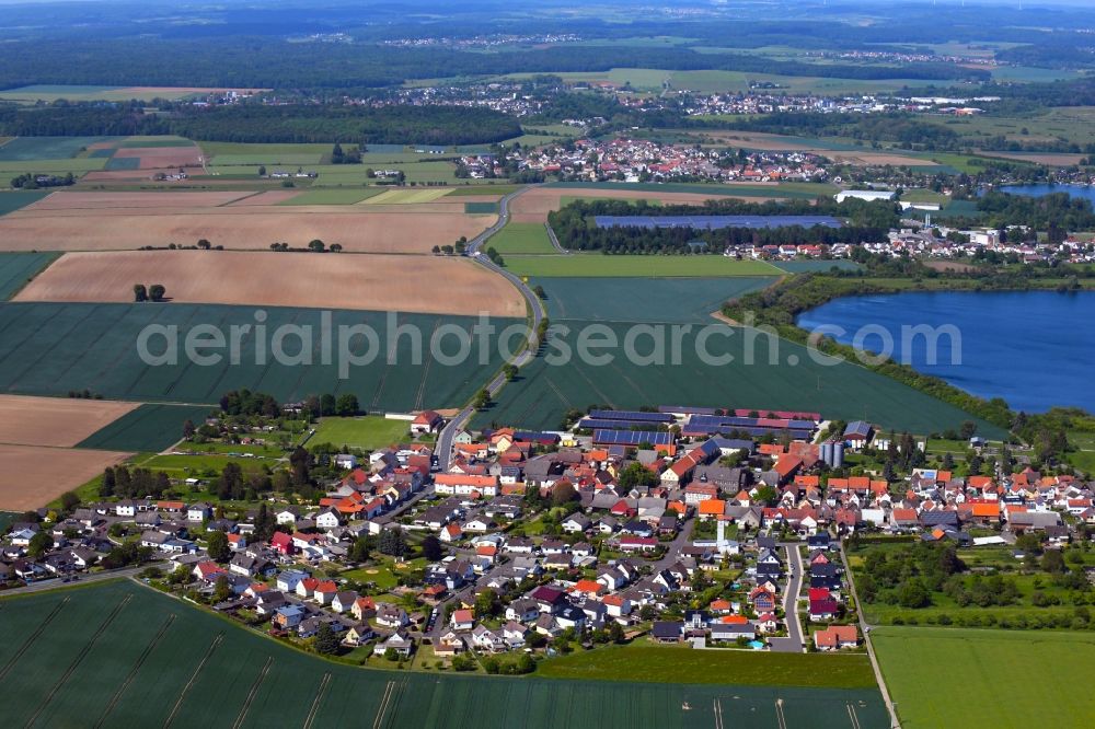 Utphe from the bird's eye view: Agricultural land and field borders surround the settlement area of the village in Utphe in the state Hesse, Germany
