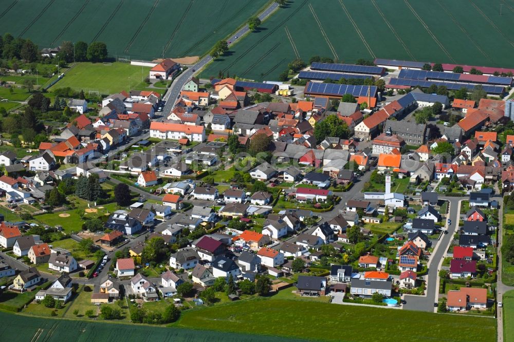Utphe from above - Agricultural land and field borders surround the settlement area of the village in Utphe in the state Hesse, Germany